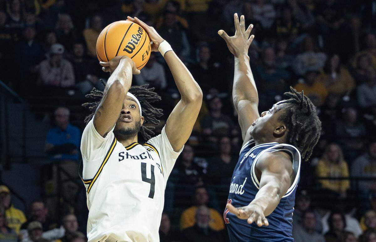 Wichita State’s Colby Rogers shoots over Richmond’s Mikkel Tyne during the first half of their game at Koch Arena on Wednesday.
