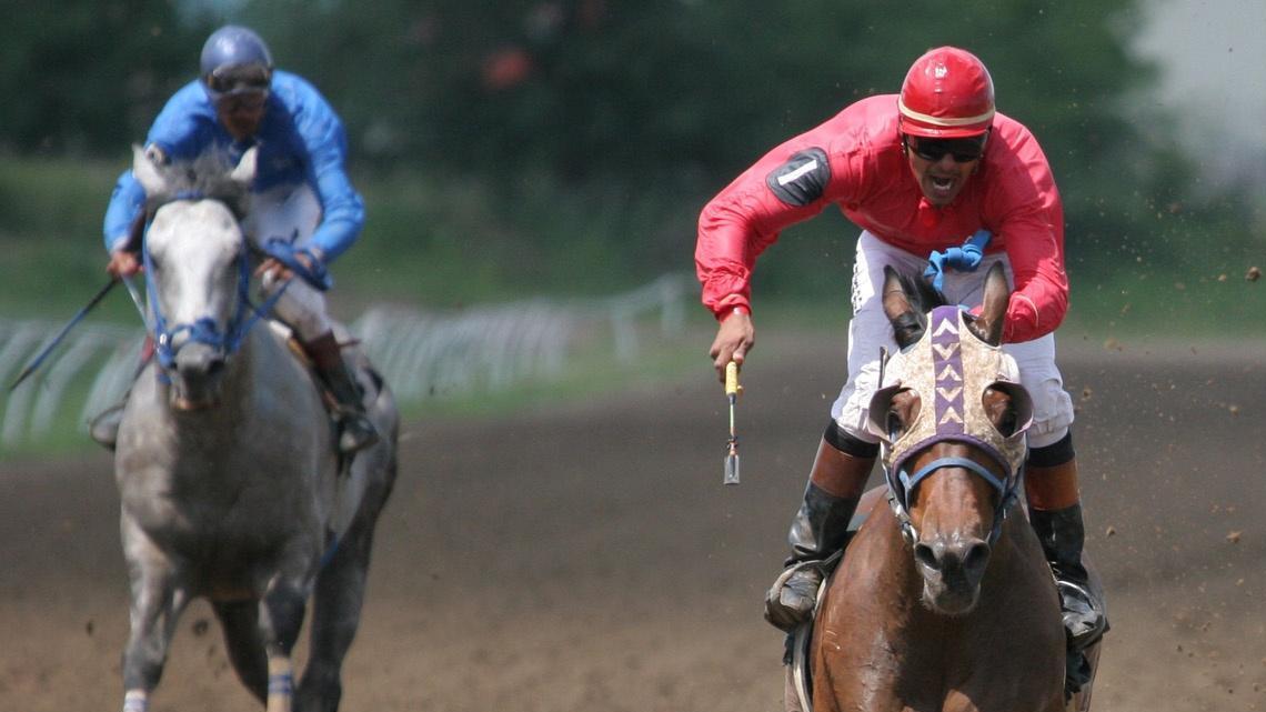 Jockeys push their horses to the finish at Eureka Downs last Saturday July 13, 2006.