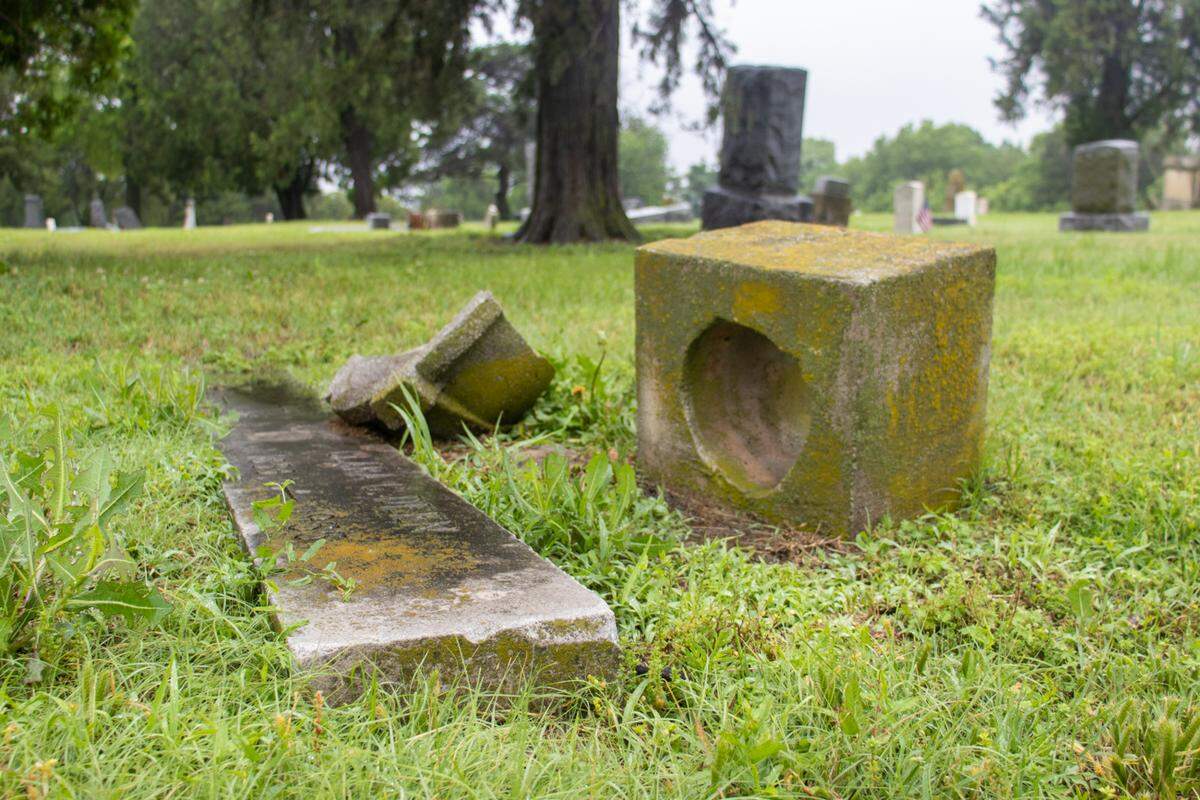 A headstone sits in disrepair at Highland Cemetery, which is owned and managed by the city of Wichita and the Department of Park & Recreation. The city is responsible for the maintenance of Highland Cemetery grounds, but the responsibility for headstone and grave stone maintenance falls to the families of those buried there.