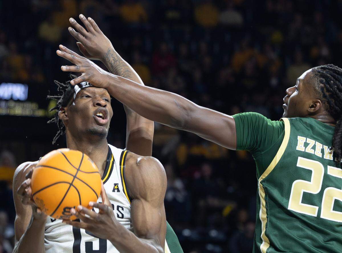 Wichita State’s Quincy Ballard gets his across the forehead by UAB’s Bradley Ezewiro during the first half on Thursday night at Koch Arena.