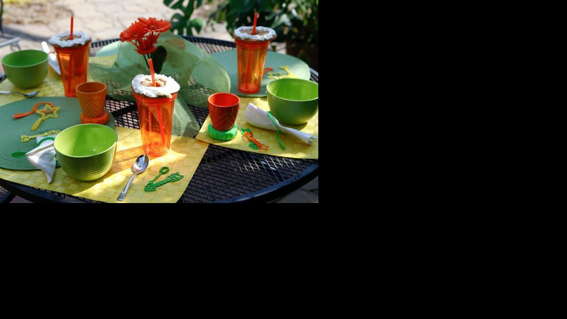 Stumped for a theme? Just chose three colors and find items around the house in that color scheme. Here orange, yellow and lime green are used to set a fun table for kids.

