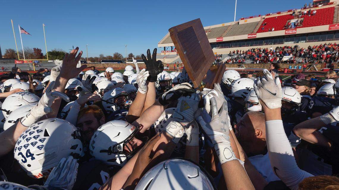 Mill Valley players celebrate their third consecutive 5A state title after beating Maize 28-15 in Pittsburg on Saturday.