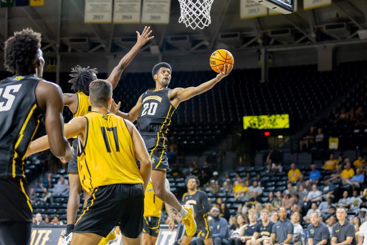 Wichita State senior Harlond Beverly soars through the air for a bucket during Shocker Madness.