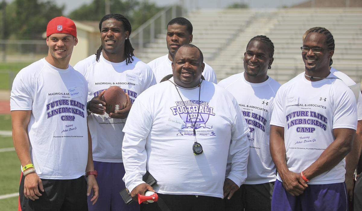 From left: Tysyn Hartman, Emmanual Lamur, Sammuel Lamur, Brian Butler, Bryce Brown and Arthur Brown Jr. pose for a picture after Arthur Brown Jr.’s Future Elite Linebackers Camp at Haysville Middle School on Saturday. (June 13, 2013)