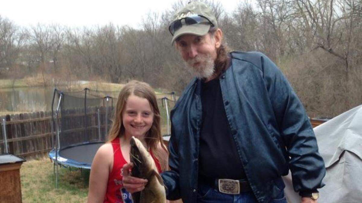 Longtime fisherman Robert “Bob” Dashiell and his granddaughter, Alyssa Pfanenstiel, in a photo from about four years ago. Dashiell died on Wednesday while fishing at a pond next to DeVaughn James Injury Lawyers.
