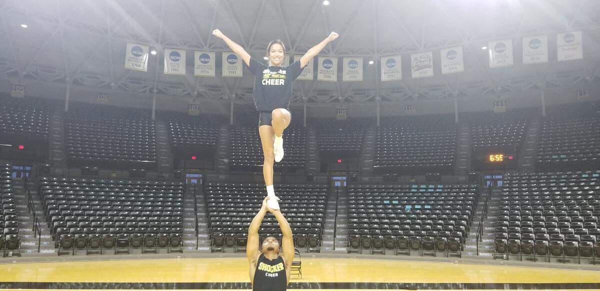 Carli McCloud performs a liberty cheer stunt with Josh Johnson as her base. McCloud, a sophomore exercise science major at WSU, has overcome a degenerative bone disorder and is now on the WSU cheerleading team.