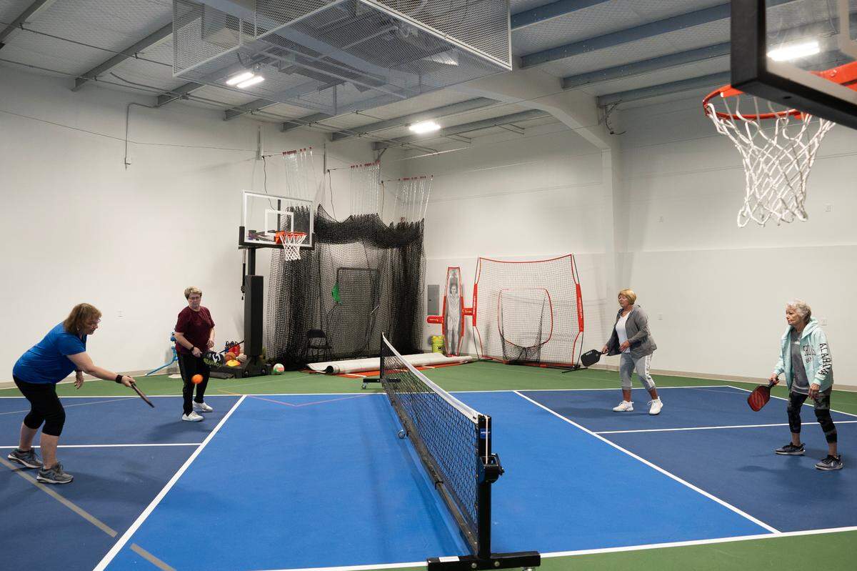 A group of women play pickleball in a unit at the Sandlot Garage Condos at 7454 W. 33rd St. N. The units are sold, not rented, and come in a variety of sizes that owners customize to fit their needs.