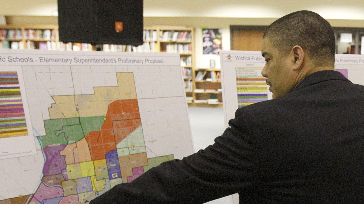 Darren Muci, division director of operations for the Wichita district, and school board member Barb Fuller look at Superintendent John Allison's boundary proposal for high schools. (February 6, 2012)

