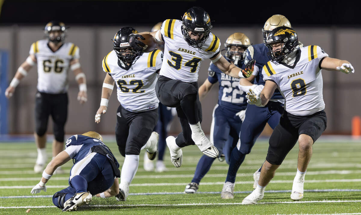 Andale running back Afton Allaire hurdles a Topeka Hayden defender during their game on Friday night in Hutchinson. The Indians beat Topeka Hayden 38-6 to win the 3A state title.