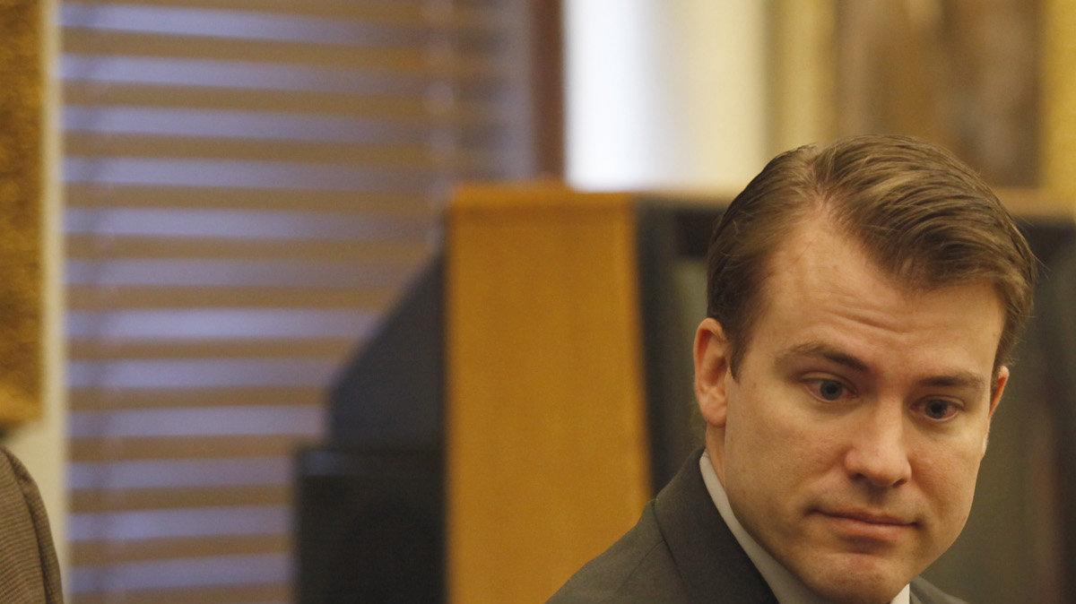 Brett Seacat leaves the courtroom during the noon recess.  Seacat is charged with first-degree murder, aggravated arson and two counts of aggravated child endangerment. He maintains his wife set fire to their Kingman home and then killed herself. He made it out of the two-story house with the coupleÕs 2- and 4-year-old sons. (November 30, 2011)