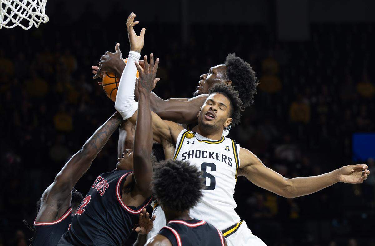Wichita State’s Corey Washington (6) Quincy Ballard battle for a rebound during the first half against Friends University on Sunday at Koch Arena.
