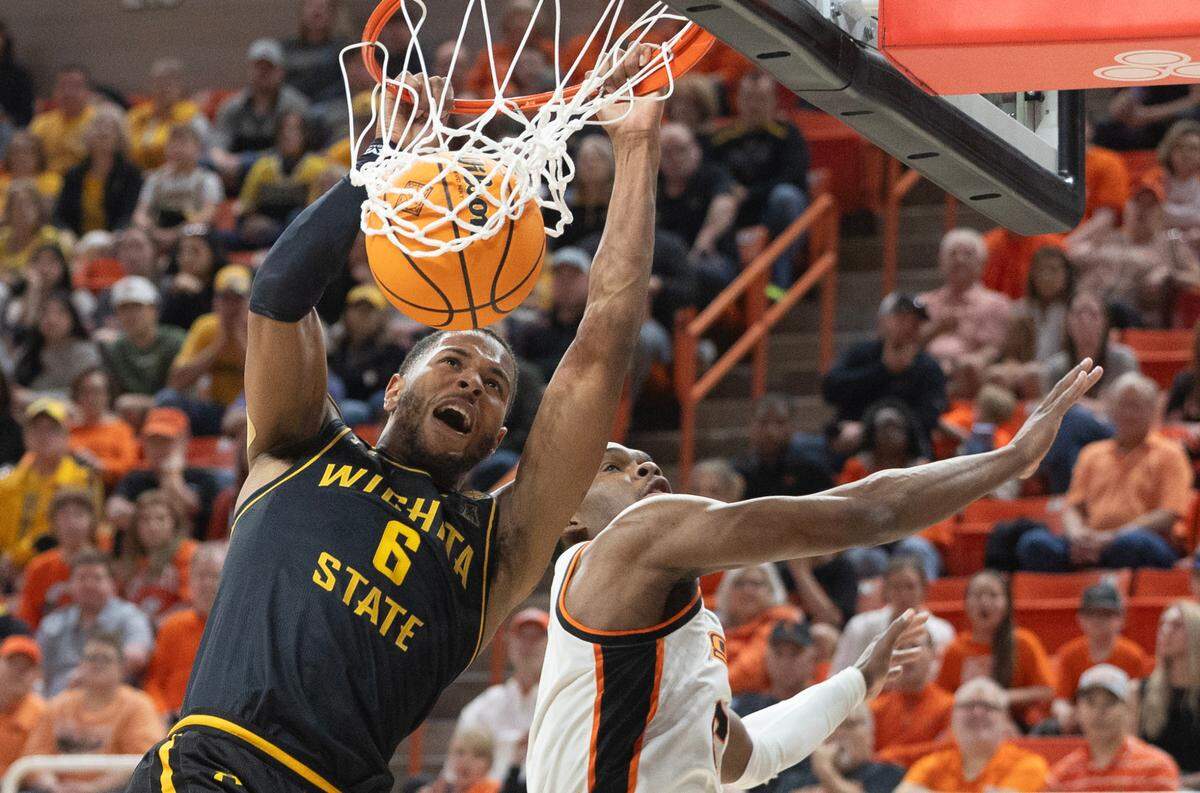 Wichita State’s Corey Washington throws down a dunk against Oklahoma State’s Brandon Newman during the first half of their first round NIT game in Stillwater, Ok.