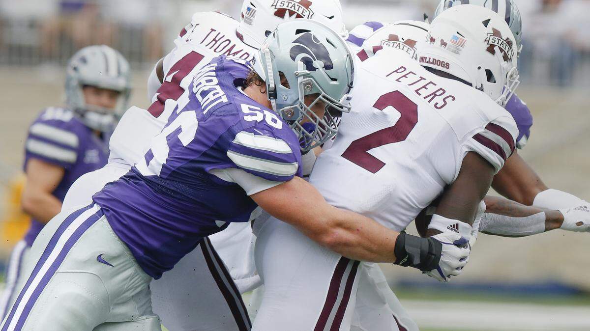 Kansas State defensive end Wyatt Hubert (56) wraps up Mississippi State cornerback Jamal Peters (2) Saturday in Manhattan. (September 8, 2018)