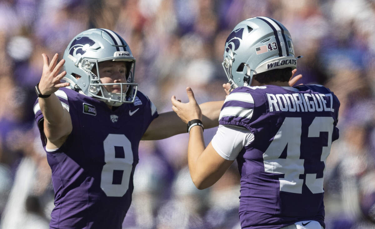 Kansas State place kicker Luis Rodriguez celebrates with holder Simon McClannan after a fourth quarter field goal all but sealed another win over Kansas for the Wildcats.