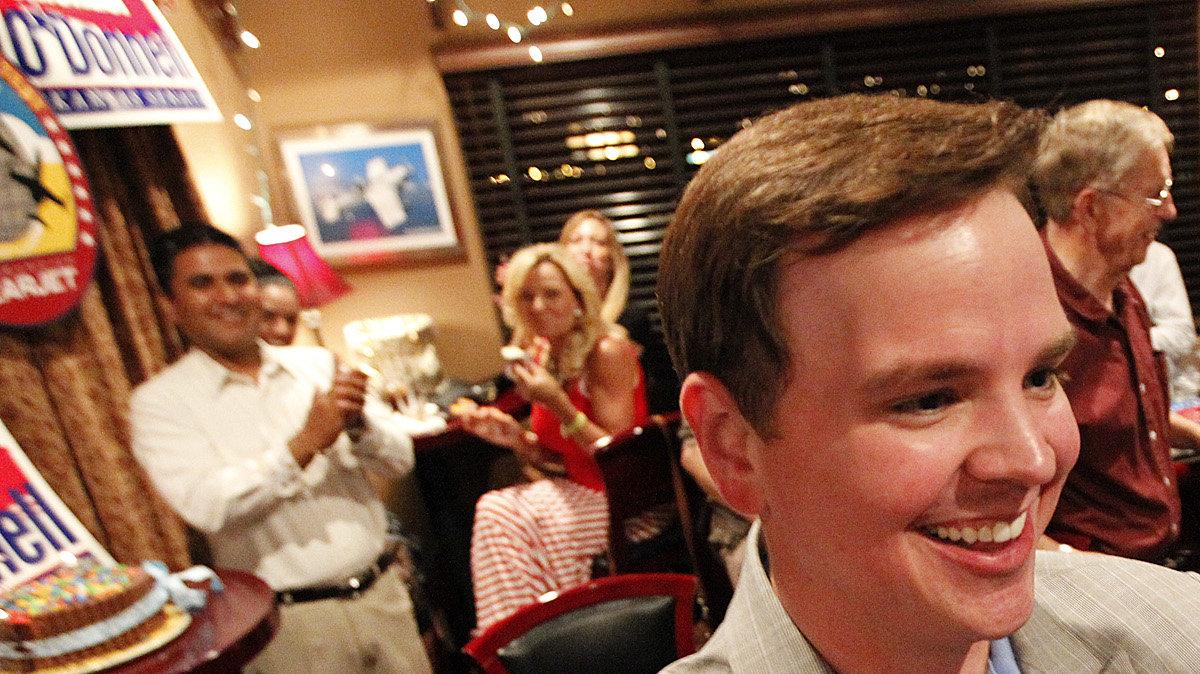 State Senate candidate Michael O'Donnell gets congratulated after he starts to pull ahead in the polls during his campaign party at Hangar One Steakhouse Tuesday. (Aug. 7, 2012)