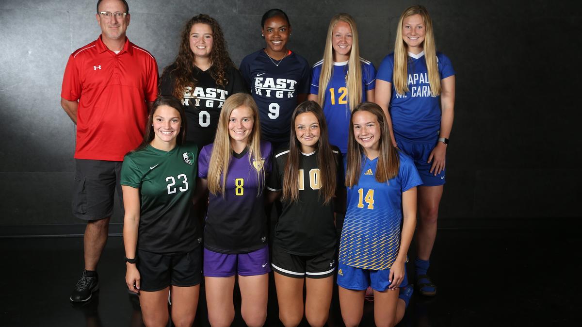All metro soccer team, from left (front row) Brianna Moore, forward, Derby High, Emma Gertz, midfield, Valley Center Angela Palmer, forward, Maize South, Maddie Reed, midfield, Collegiate.  (Back row) Coach Jay Holmes,  Maria Vega  goal keeper East High, Brynn Walker, East High,  Emily Jensen, forward,  Wichita Northwest, Mary Clair Boulanger,  Kapaun Mt. Carmel (Not pictured: Maize's Ashlyn Lakin, Carroll's Maguire Sullivan) (June 4, 2018)