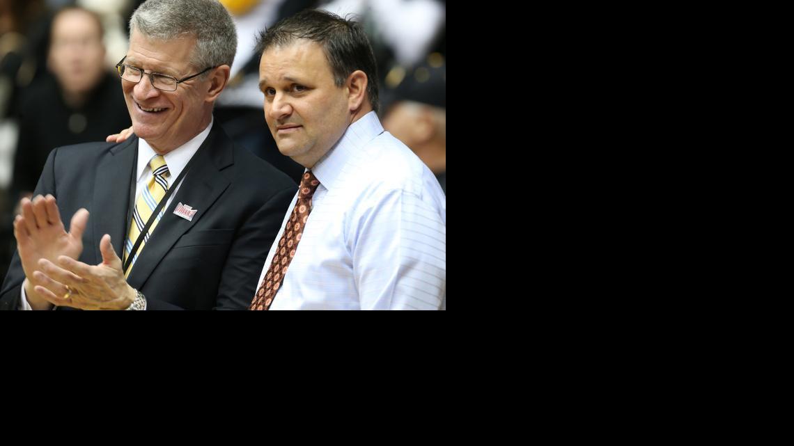 Missouri Valley Conference commissioner Doug Elgin, left, with WSU associate head coach Chris Jans after WSU celebrated the MVC regular-season crown March 1, thinks the Valley’s other nine schools will continue to improve after a down 2013-14.

