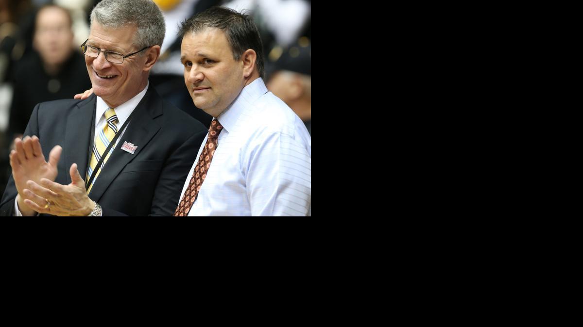 Missouri Valley Conference commissioner Doug Elgin, left, with WSU associate head coach Chris Jans after WSU celebrated the MVC regular-season crown March 1, thinks the Valley’s other nine schools will continue to improve after a down 2013-14.

