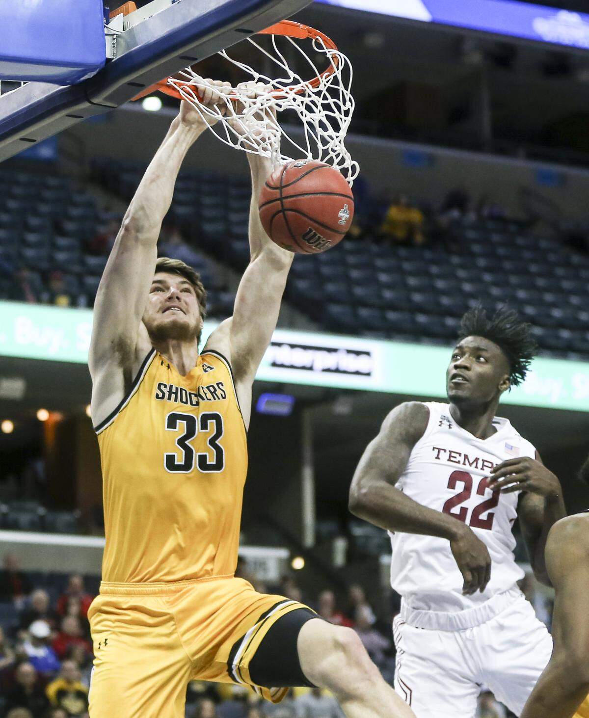 Wichita State center Asbjorn Midtgaard dunks over Temple forward De’Vondre Perry during the second half of their American Athletic Conference quarterfinal game in Memphis on Friday.