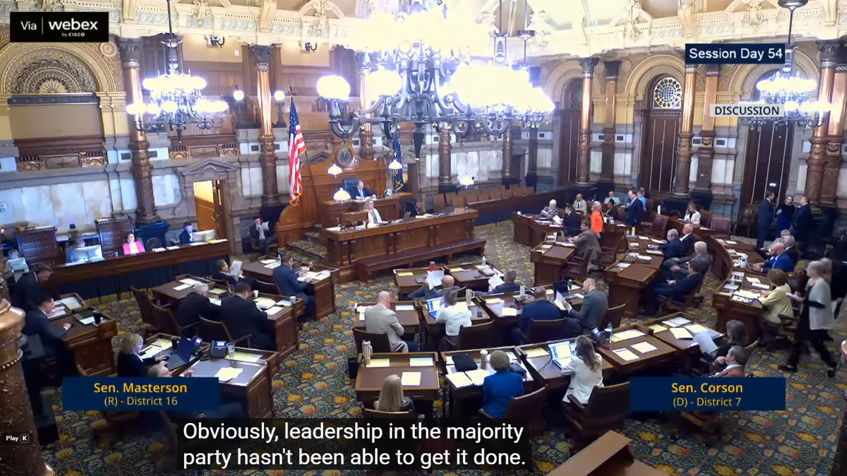 Sen. Ethan Corson debates property tax relief on the floor of the Kansas Senate with Senate President Ty Masterson.