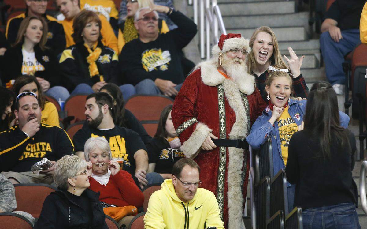 Wichita State fans take a picture with Mike Furches before the game against Tennesse at Intrust Bank Arena. The Shockers won 70-61 in front of 14,356 people. (December 14, 2013)