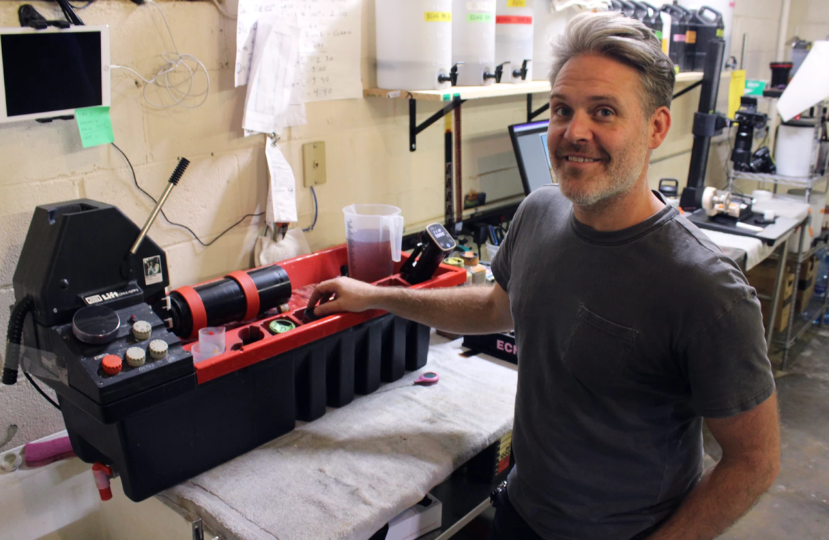 Justin Cary, owner of Midwest Film Company, manually develops some still film photos using this black and red processor.