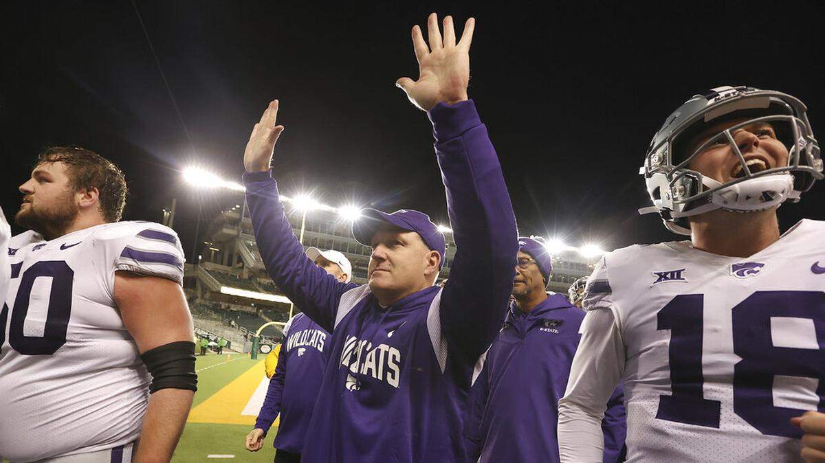 Kansas State head coach Chris Klieman, center, thanks the fans after defeating Baylor in an NCAA college football game, Saturday, Nov. 12, 2022, in Waco, Texas. (AP Photo/Jerry Larson)