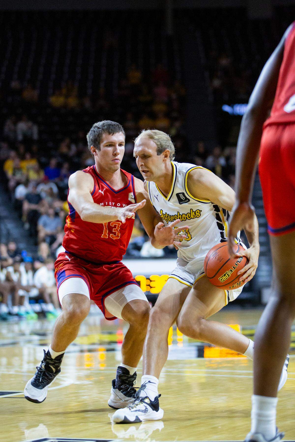 Conner Frankamp attempts to drive down the court before being halted by a player from Midtown Prestige.