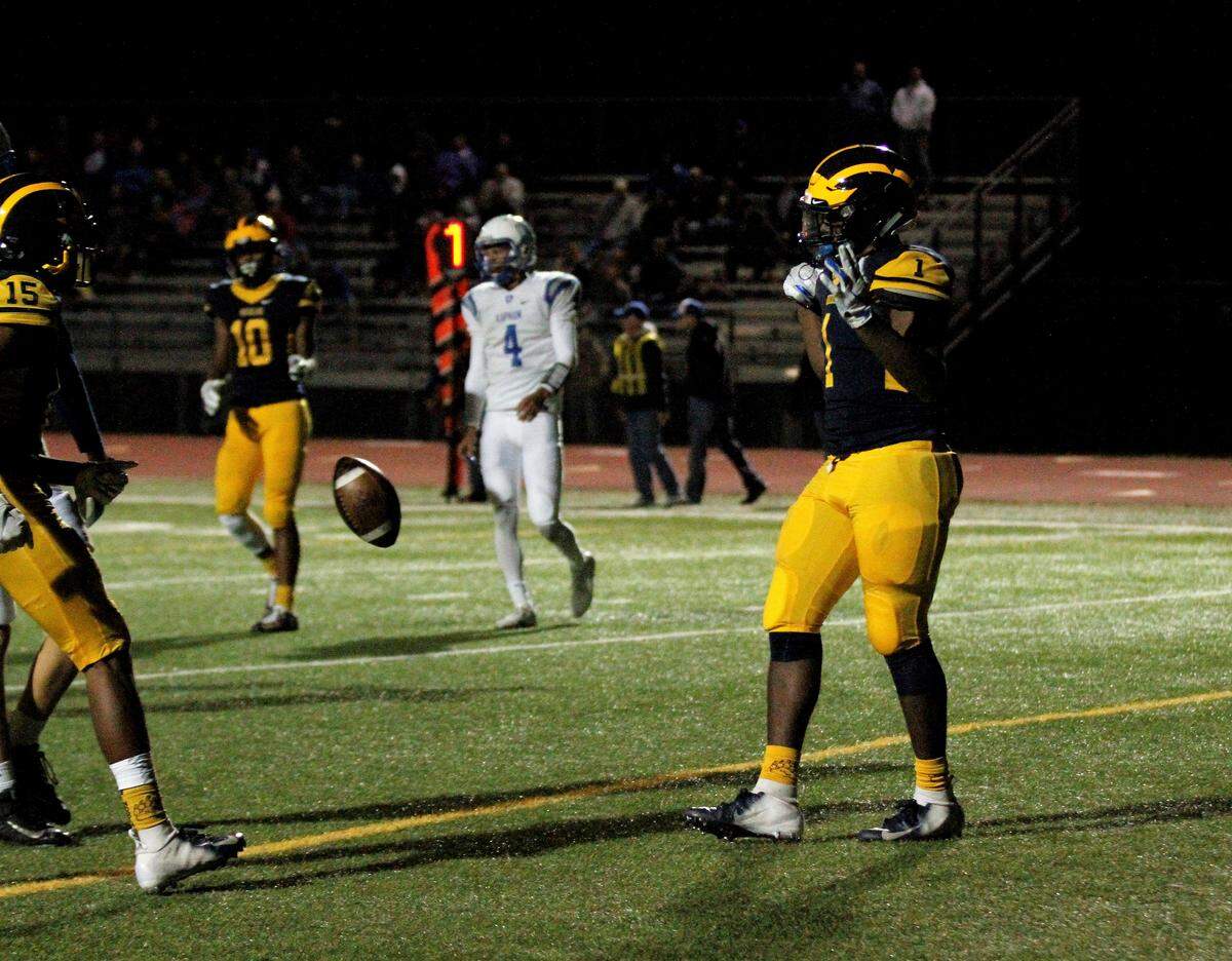 Wichita Northwest’s Breece Hall throws the football after scoring his fourth touchdown in the Grizzlies’ 55-26 win over Kapaun on Friday. (Sept. 28, 2018)