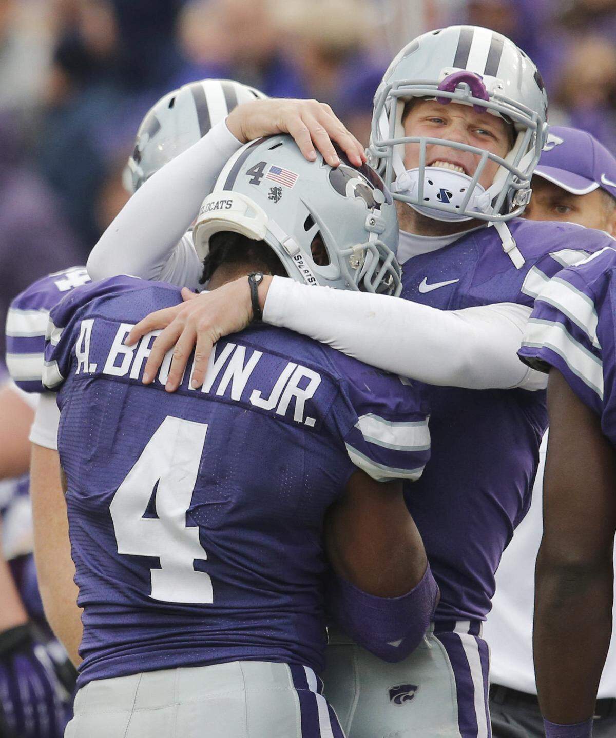 Kansas State Wildcats quarterback Collin Klein (7) hugs linebacker Arthur Brown (4) after after Brown intercepted Texas Tech Red Raiders quarterback Seth Doege (7) pass in the 4th quarter for a 37 yard interception return and touchdown.(Oct 27, 2012)