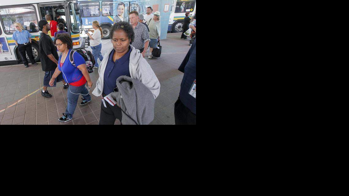 Bus riders make their connections at the downtown transit center Thursday. (July 31, 2014) 

