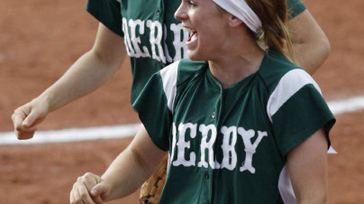 Derby came back to defeat Lawrence Free State 3-2 in one extra inning on Thursday, May 23. 2013, in the KSHSAA State Softball Championship quarterfinals at Blue Valley West High School in Overland Park. Derby's center fielder Kenzi Young (foreground) as all smiles after doubling a runner off second base to end the game. Behind her was shortstop Tori Miller.