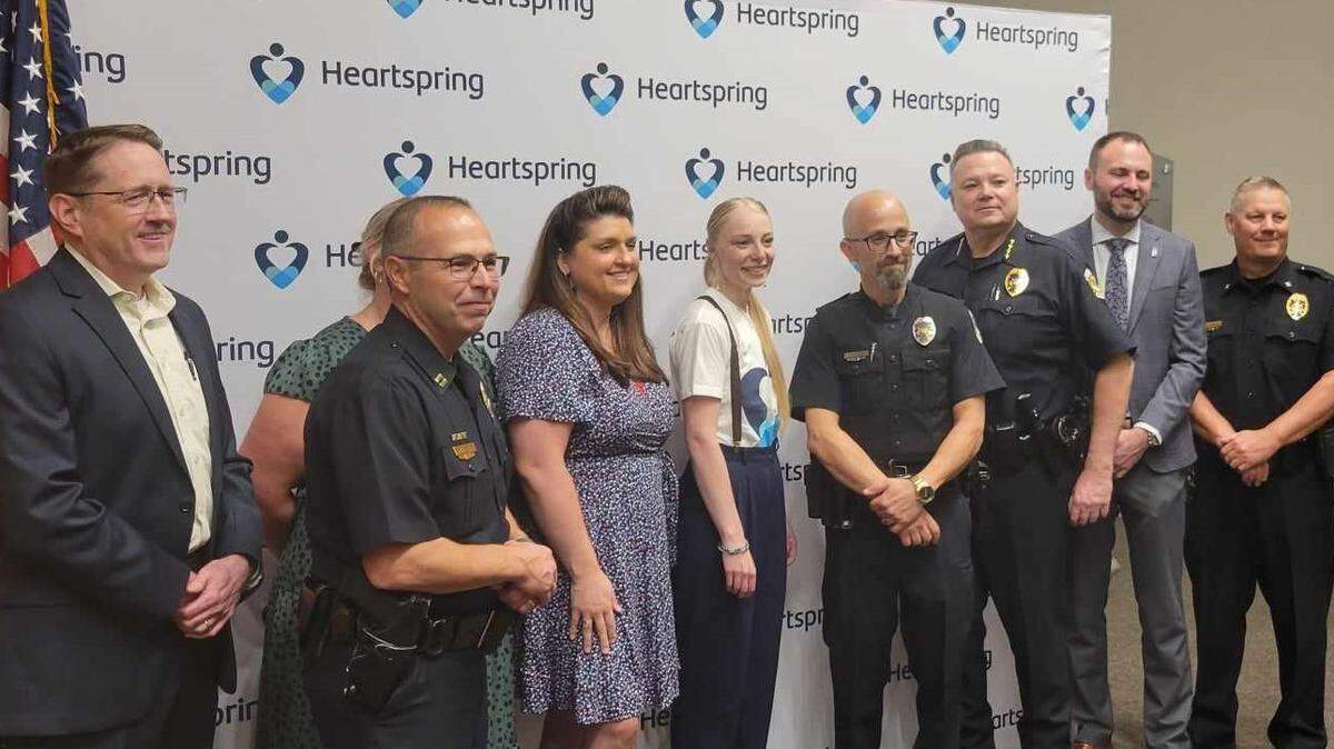 Representatives from the Wichita Police Department, Sedgwick County Sheriff’s Office, Scheels and Heartspring pose for a photo Friday after an announced collaboration to help officers be more prepared to interact with people who have autism or are non-communicative.