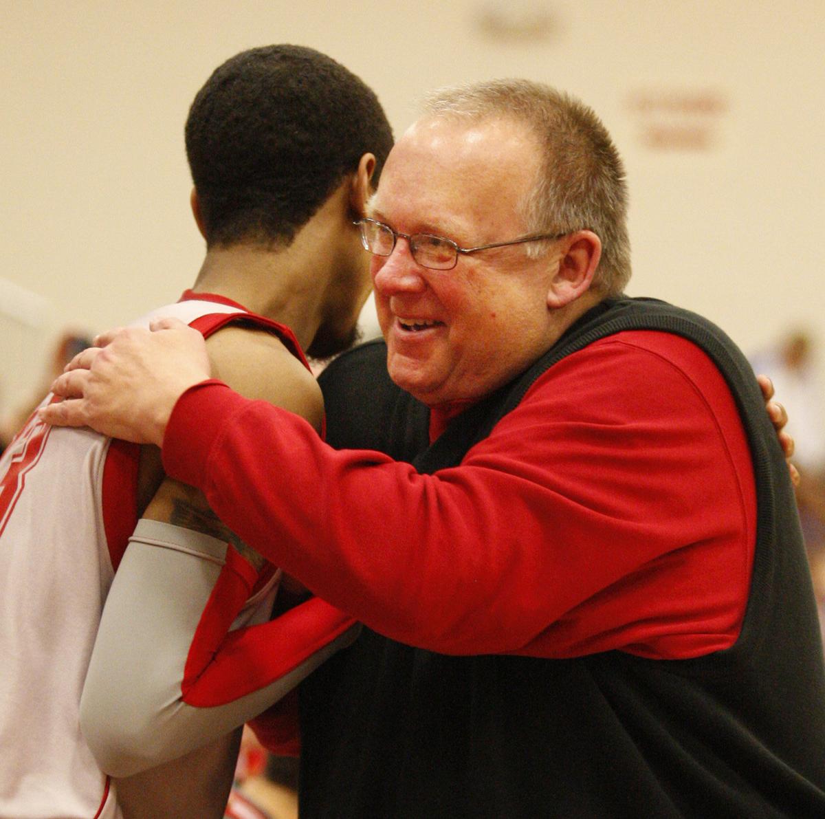 Friends’ coach Dale Faber, right hugs Chris Jackson as he goes down the line congratulating each player after their victory over Bethany College Tuesday (March 2, 2010) at Friends University.
