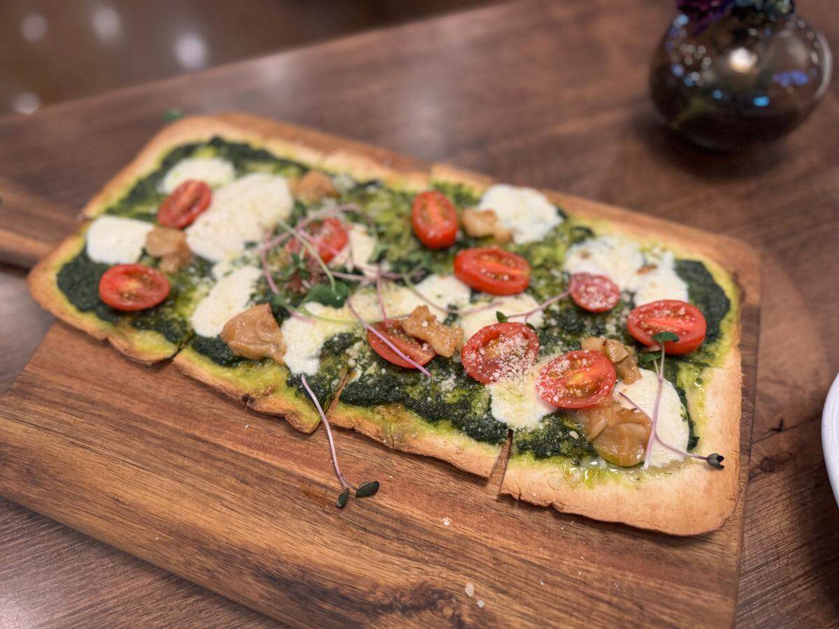 The lavash appetizer at Sheet’s Creek is made with roasted garlic, tomato, Parmesan, mozzarella and an olive oil and basil puree.
