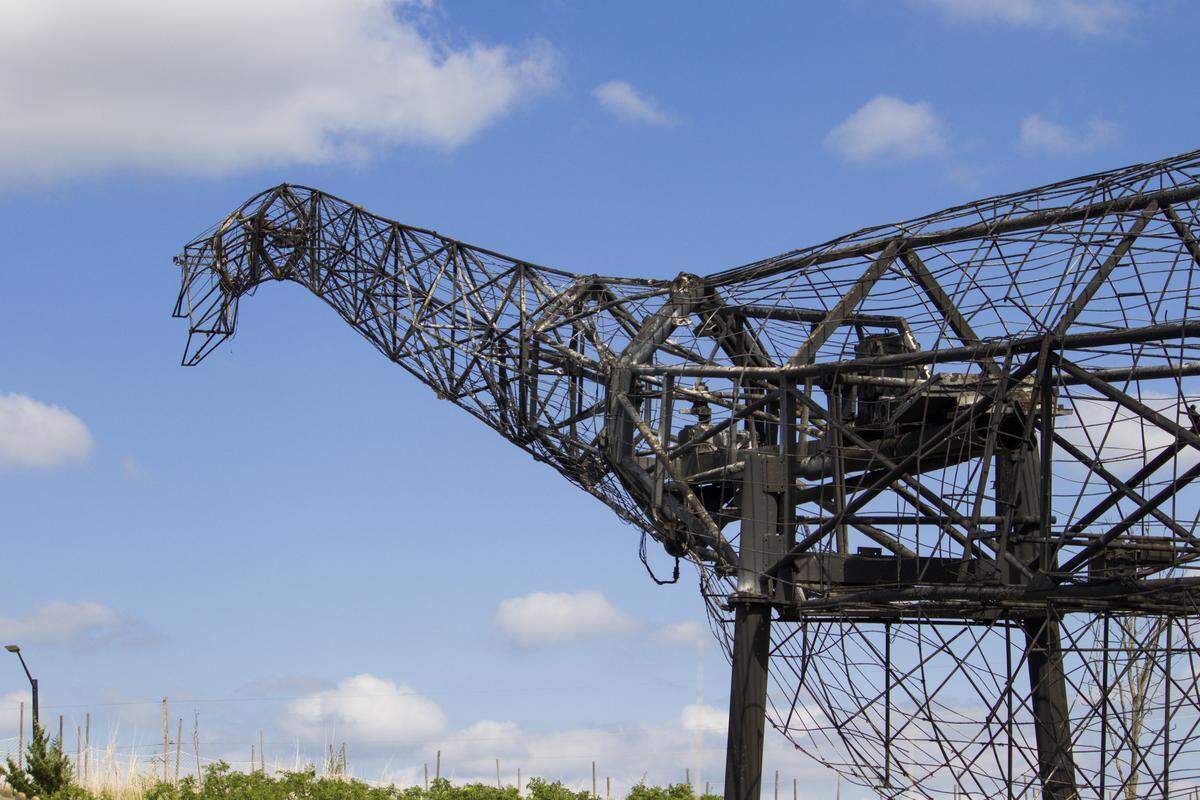 A 100-foot-long, 60-ton Sauroposeidon animatronic was reduced to its frame after being struck by lightning and catching fire Saturday night.