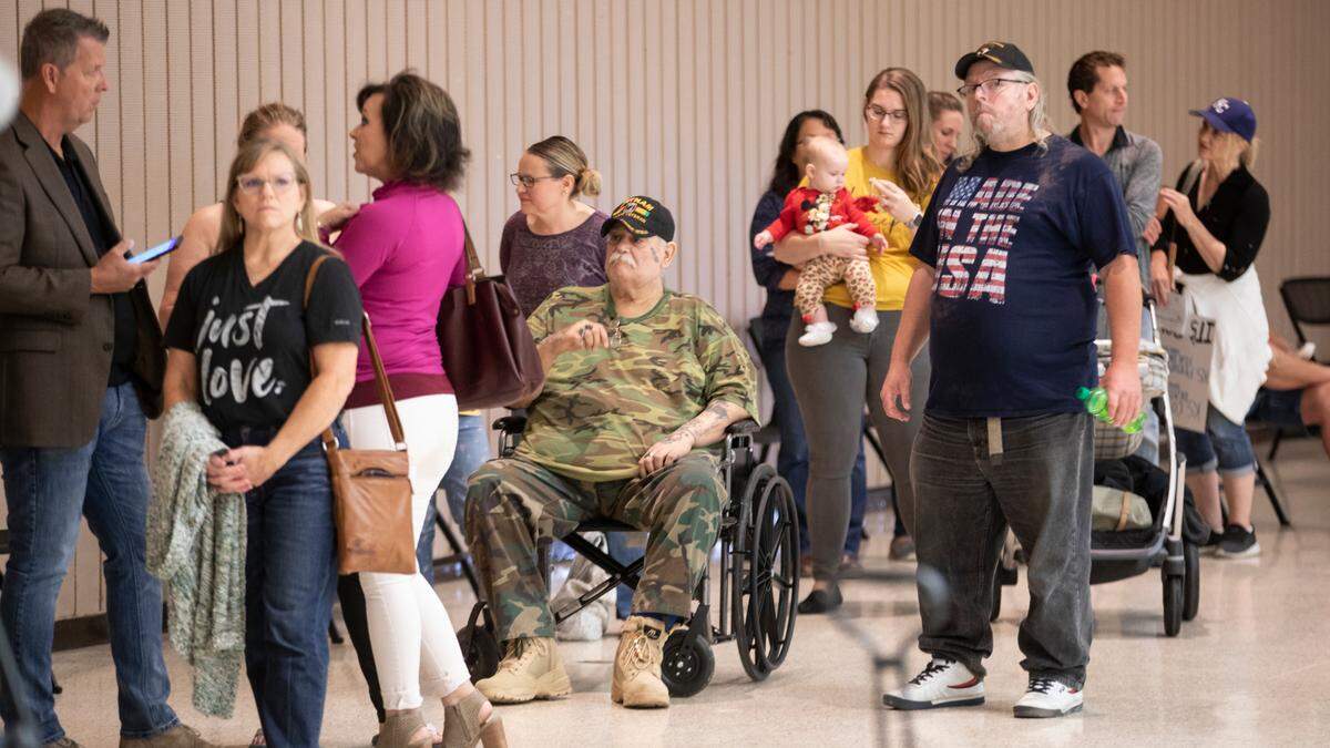 People line up to speak inside Century II Tuesday, defying a city policy on social distancing in public buildings and an ordinance requiring masks to reduce COVID-19 spread.