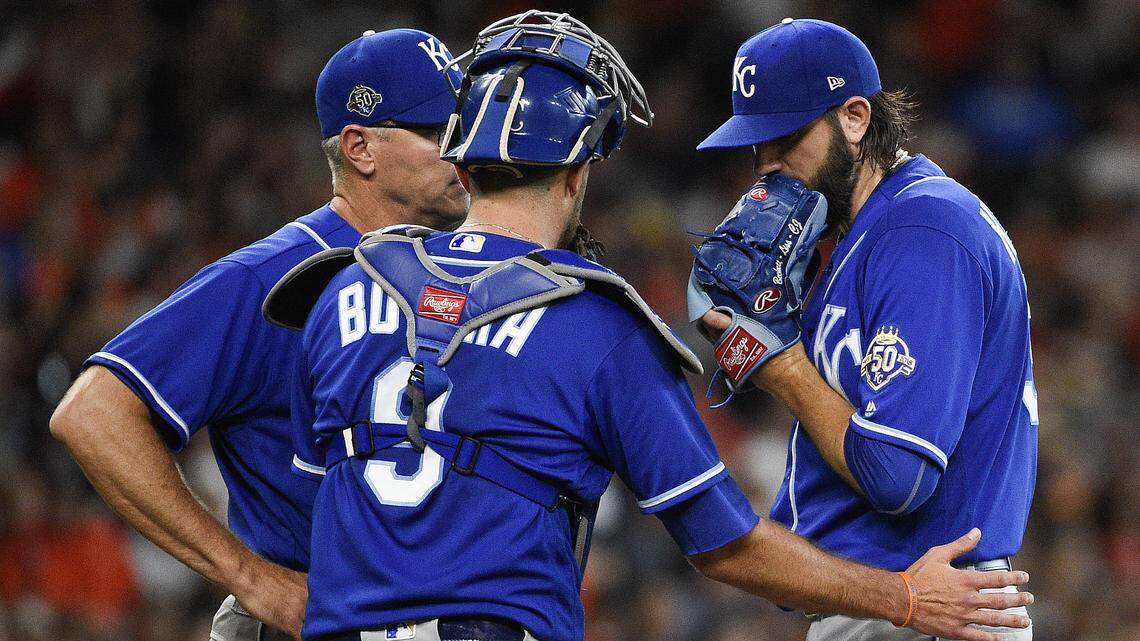 Kansas City Royals starting pitcher Jason Hammel, right, talks with catcher Drew Butera, center, and pitching coach Cal Eldred, left, during the second inning Sunday in Houston.