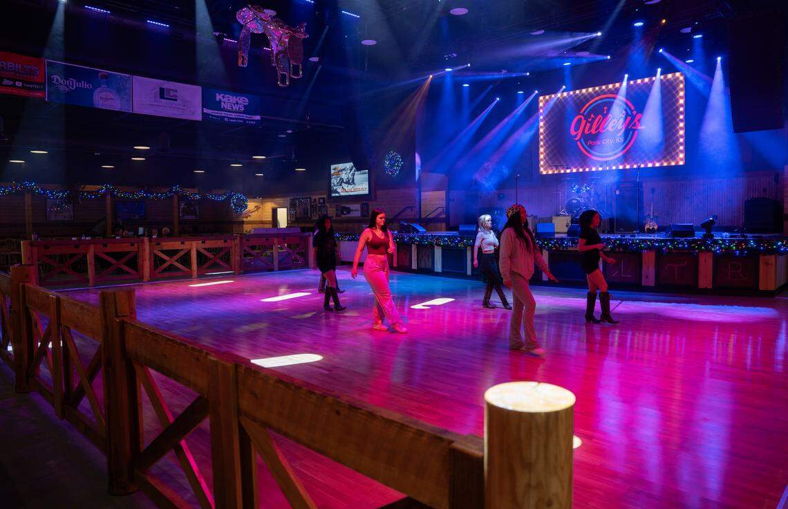 Gilley Girls, who will be responsible for creating energy and getting people to dance at the new Gilley’s honky-tonk, practice their steps ahead of Monday’s opening.