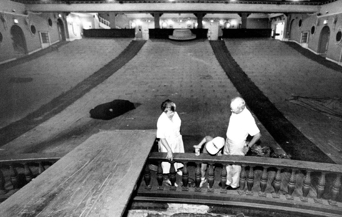Orpheum board members inspect the theater after its seats were torn out.