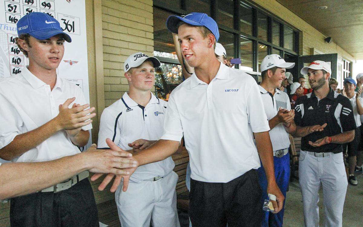  Kapaun Mt. Carmel's Sam Stevens picks up his first place medal after the 5A State Tournament in 2014 at the Wichita Country Club Tuesday. 