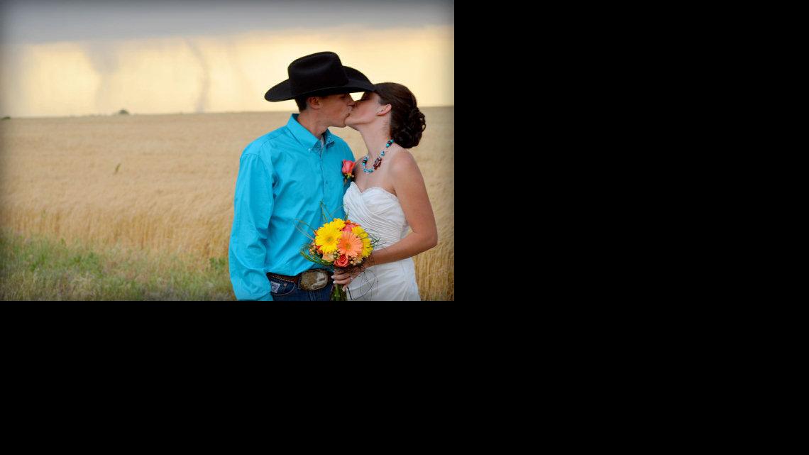 Photographer Cate Eighmey photographed newlyweds Caleb and Candra Pence with a tornado in the background in Harper County last Saturday.