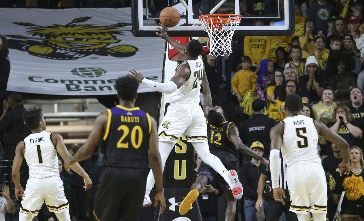 Wichita State’s Morris Udeze makes a huge block late in the game against East Carolina’s Termont Robinson during the second half of their game at Koch Arena on Wednesday.
