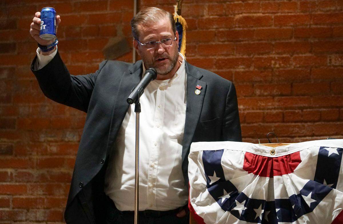 Democrat James Thompson toasts the win of Laura Kelly for Kansas governor after the Associated Press called the 4th Congressional District race for Republican Ron Estes. Thompson told his supporters not to throw away yard signs because they might need them in the future. (November 6, 2018)