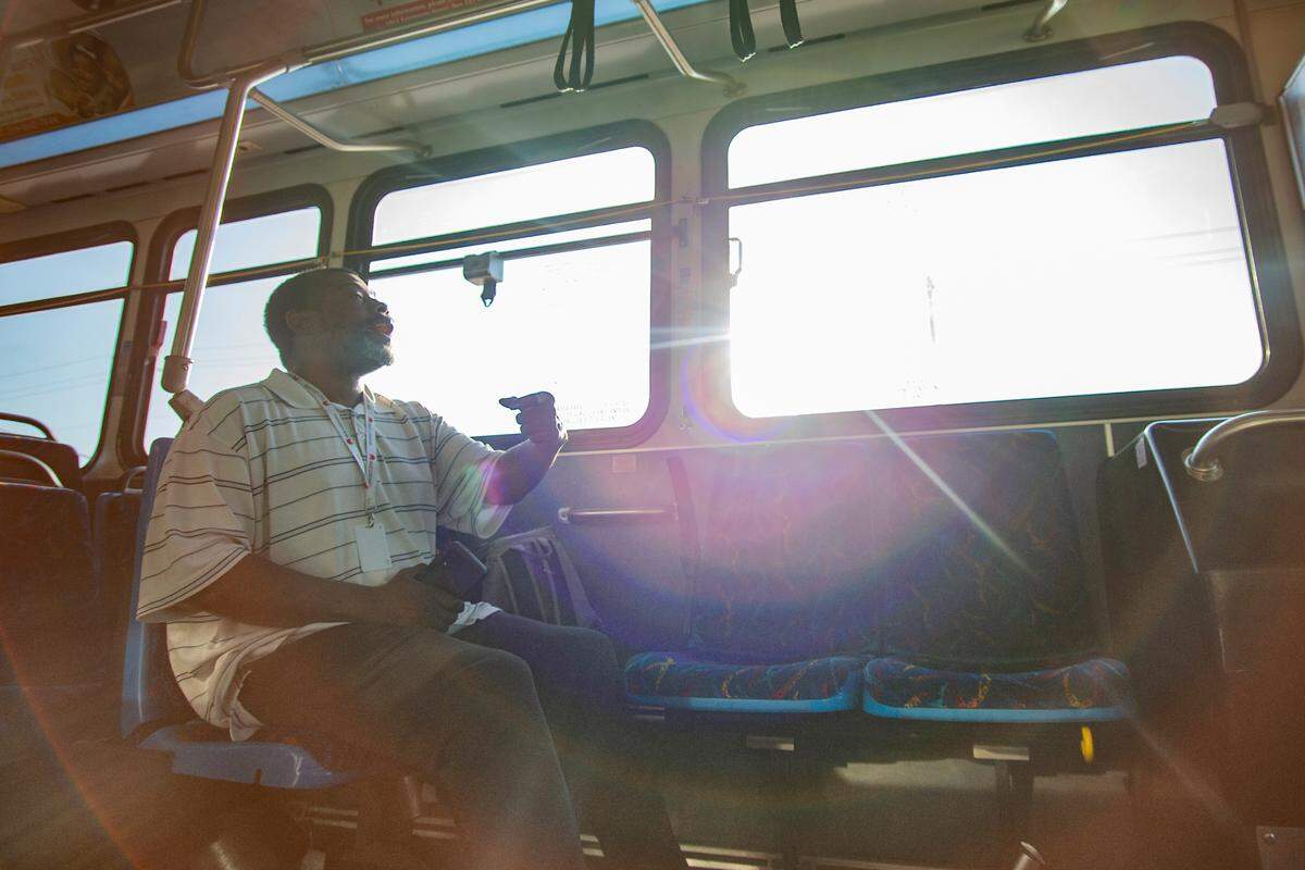John Vaden, a frequent Wichita bus rider, speaks to Mario White on July 11. Vaden rode Route 201 to his job at CLC Lodging .