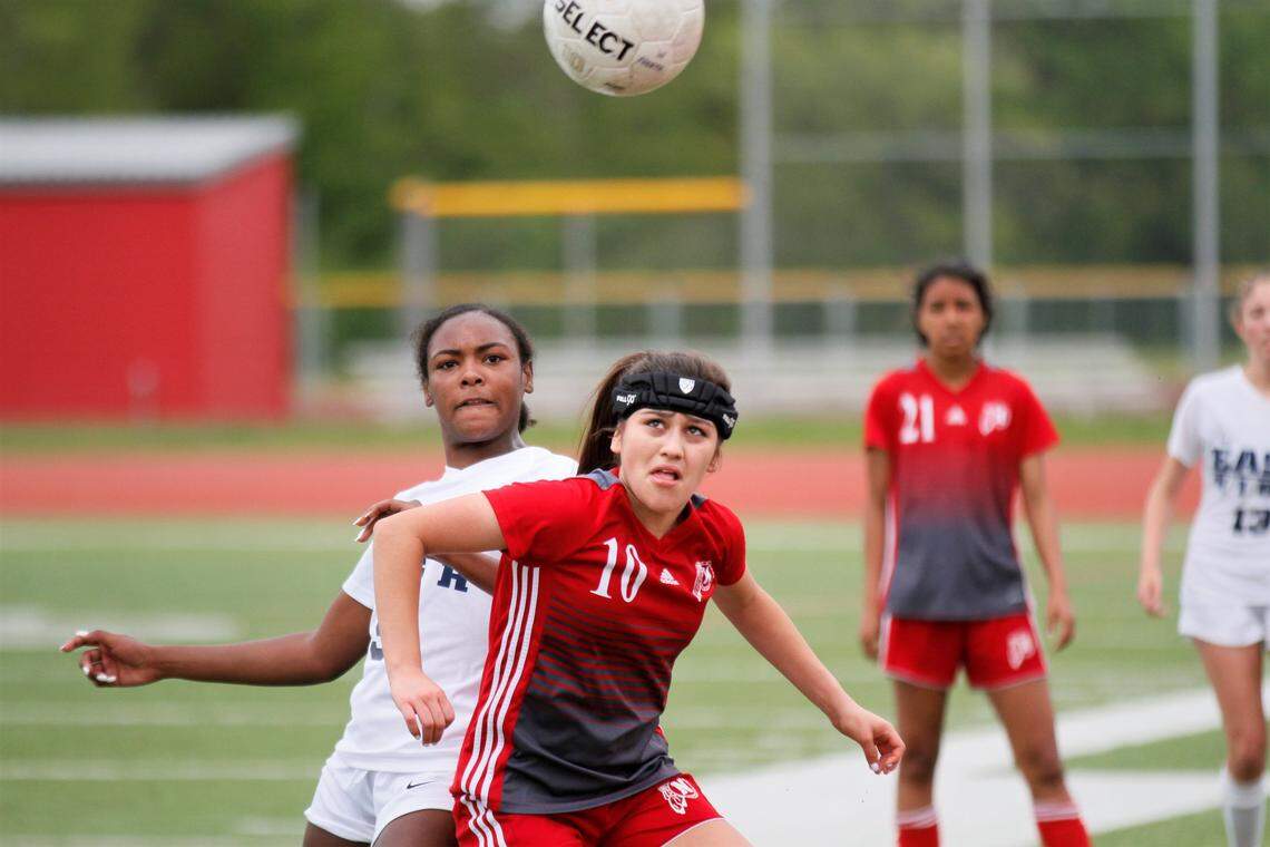 Wichita East’s Brynn Walker and North’s Nayeli Gallo