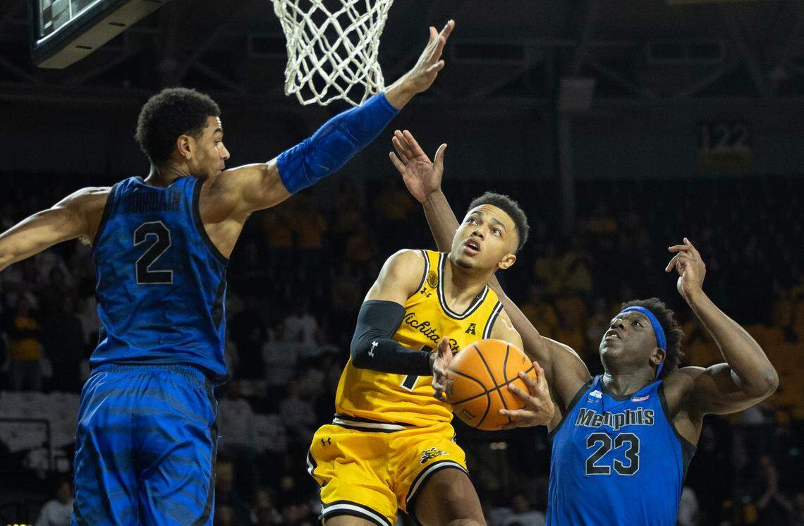 Wichita State’s Xavier Bell goes up for a shot against Memphis defenders Malcolm Dandridge, right, and Nicholas Jourdain, left, during the first half on Sunday at Koch Arena.