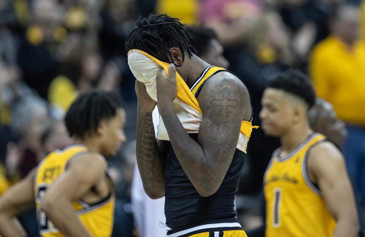 Wichita State’s Jaykwon Walton hides his face after the Shockers lost to San Francisco in the final of the Hall of Fame Classic in Kansas City on Tuesday. Walton had 21 points, but committed a crucial turnover late in the game.