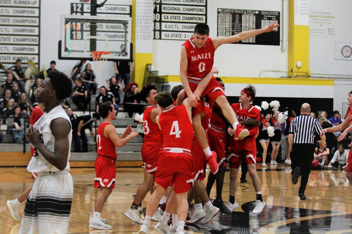 Maize senior Caleb Grill goes soaring into his teammates after the Eagles’ 46-45 road win over Campus on Friday night. (Feb. 8, 2019)