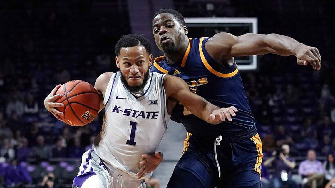 Kansas State guard Markquis Nowell (1) drives under pressure from Kansas City forward Allen David Mukeba Jr. during the first half of an NCAA college basketball game Thursday, Nov. 17, 2022, in Manhattan, Kan. (AP Photo/Charlie Riedel)